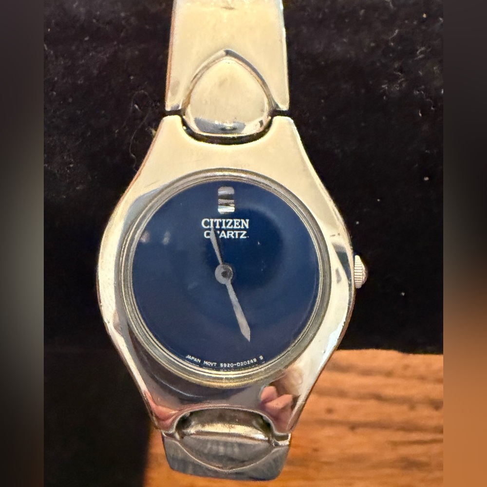 Citizen womans silver tone bangle style watch with deep blue face